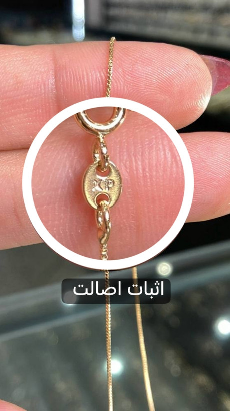 تصویر نمای نزدیک زنجیر ونیزی ژوپینگ اورجینال با آبکاری طلایی و پلاک حکشده XP، بهعنوان نشانه اصالت محصول
